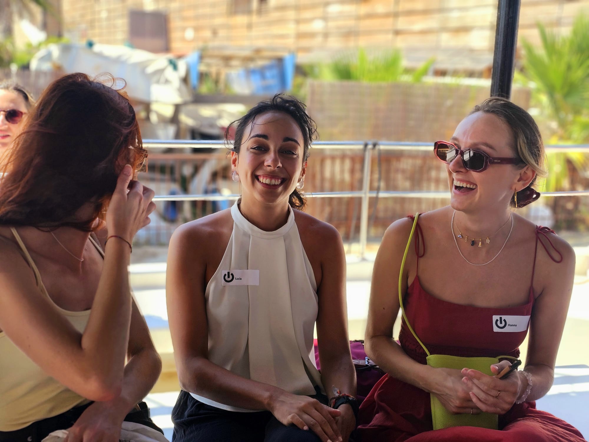 Team socializing outdoors with drinks at company event
