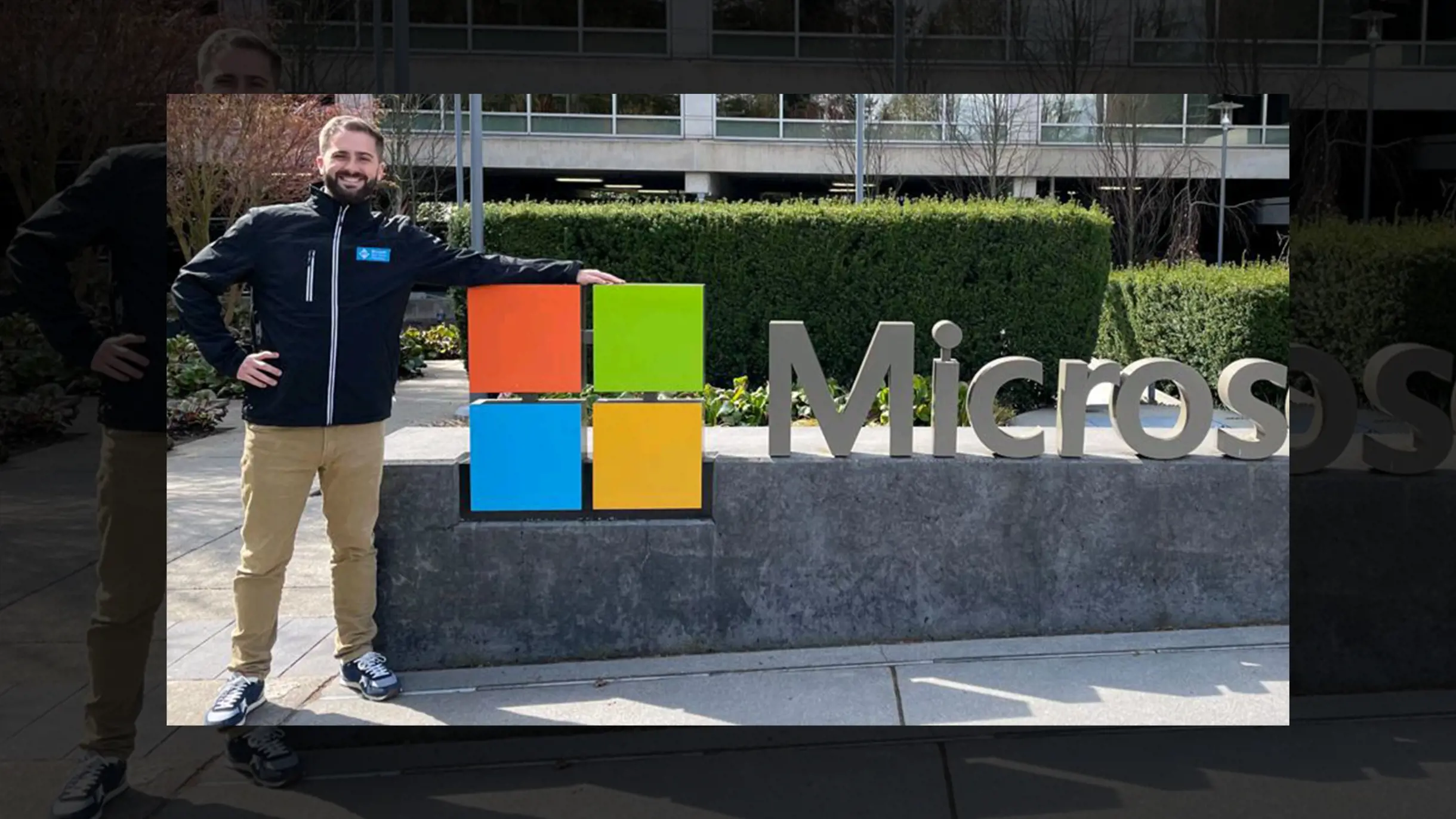 Man standing in front of the Microsoft logo in Redmont