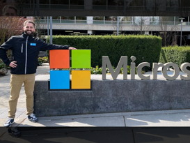 Man standing in front of the Microsoft logo in Redmont