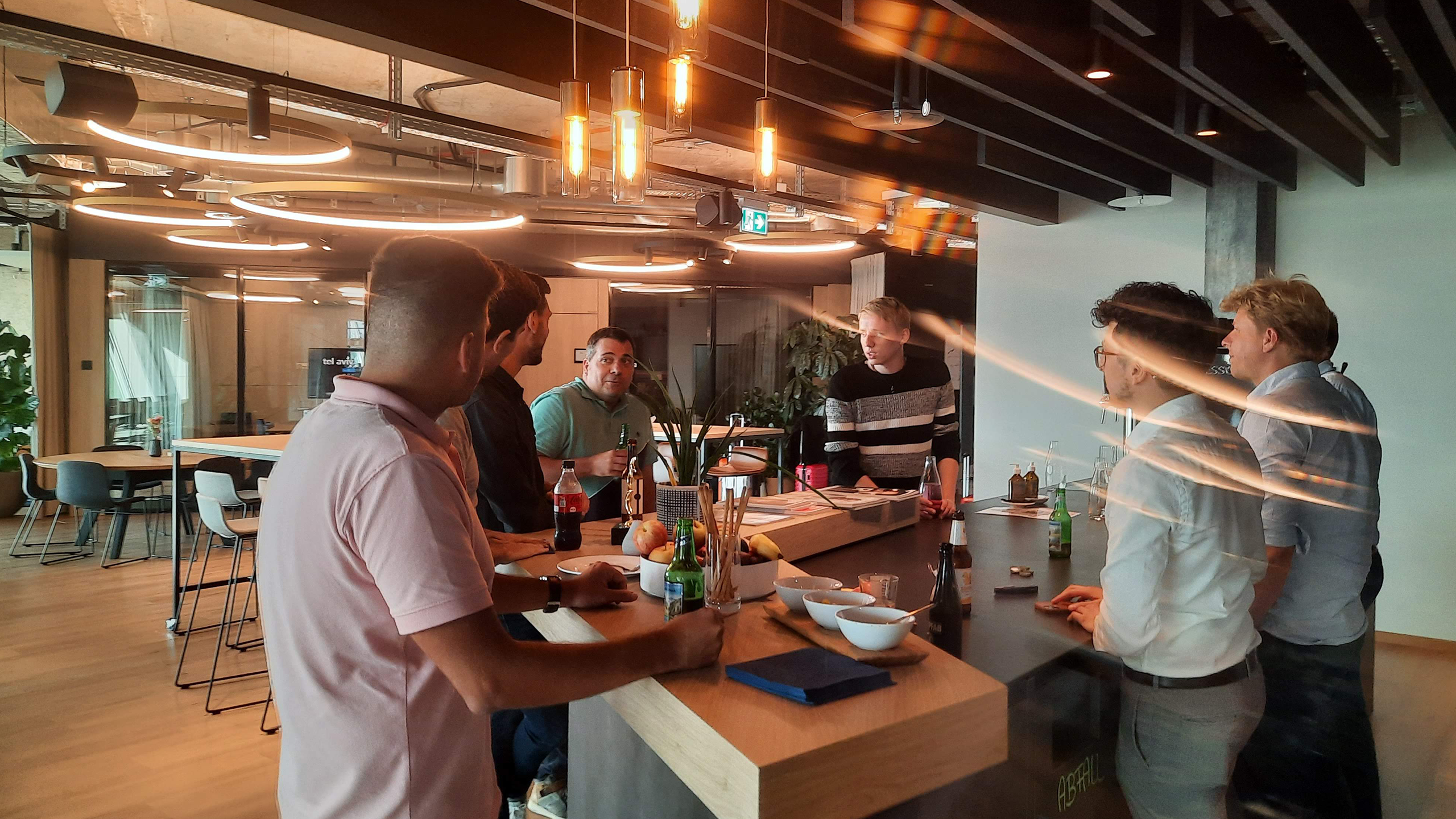People standing in the kitchen eating tapas