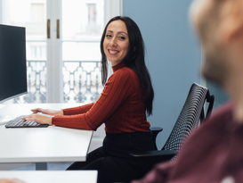 Team - Workplace Woman in red top happily at work
