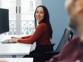 Woman in red top happily at work