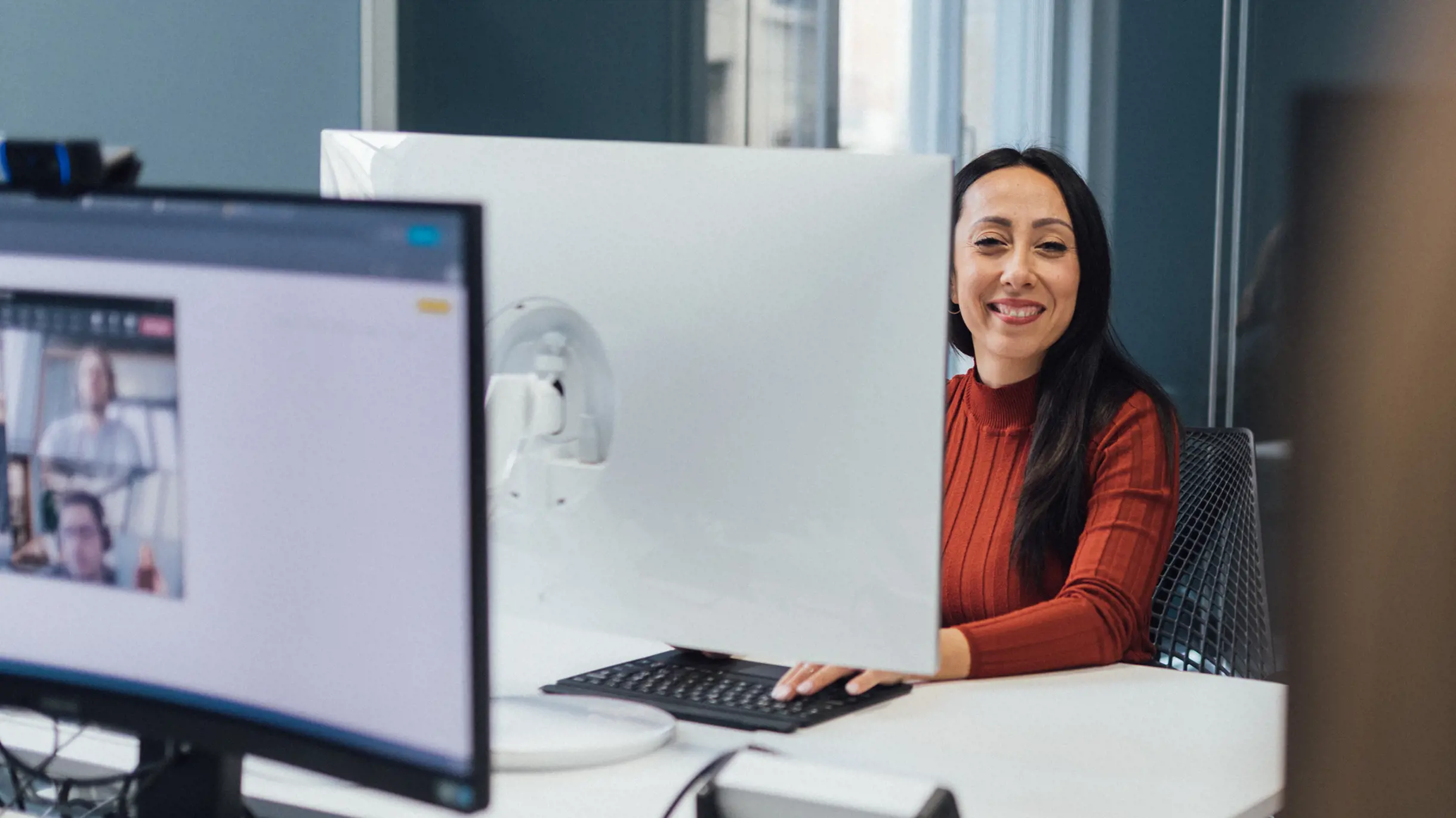 Woman in red top happily at work