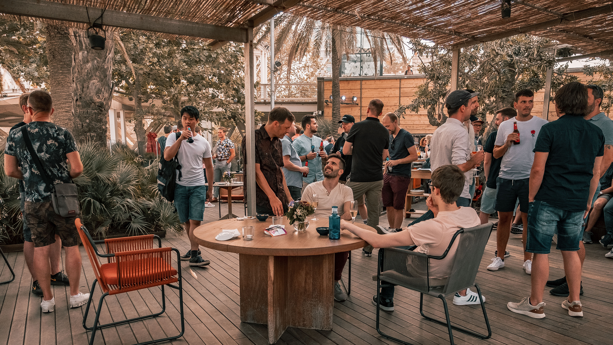 Terrace with some furniture and people sitting and standing around