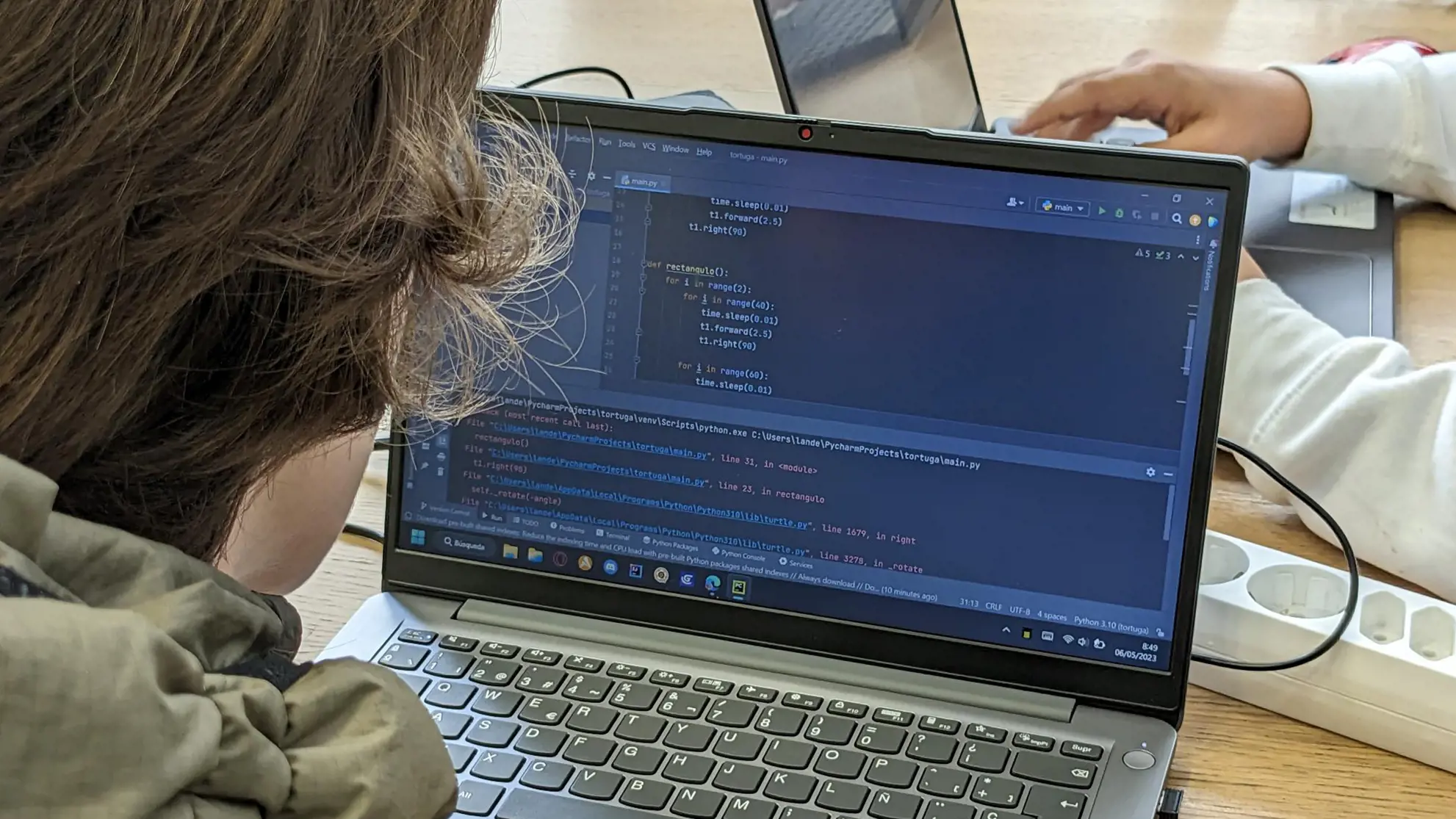 Kid sitting in front of a laptop coding