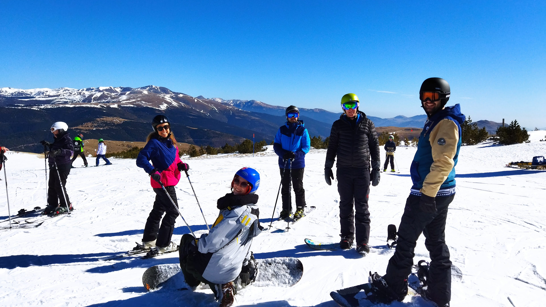 Group of people in the snow wearing ski gear