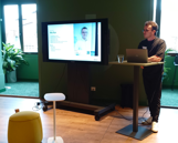 Man standing close to a Surface Hub giving a technical speech
