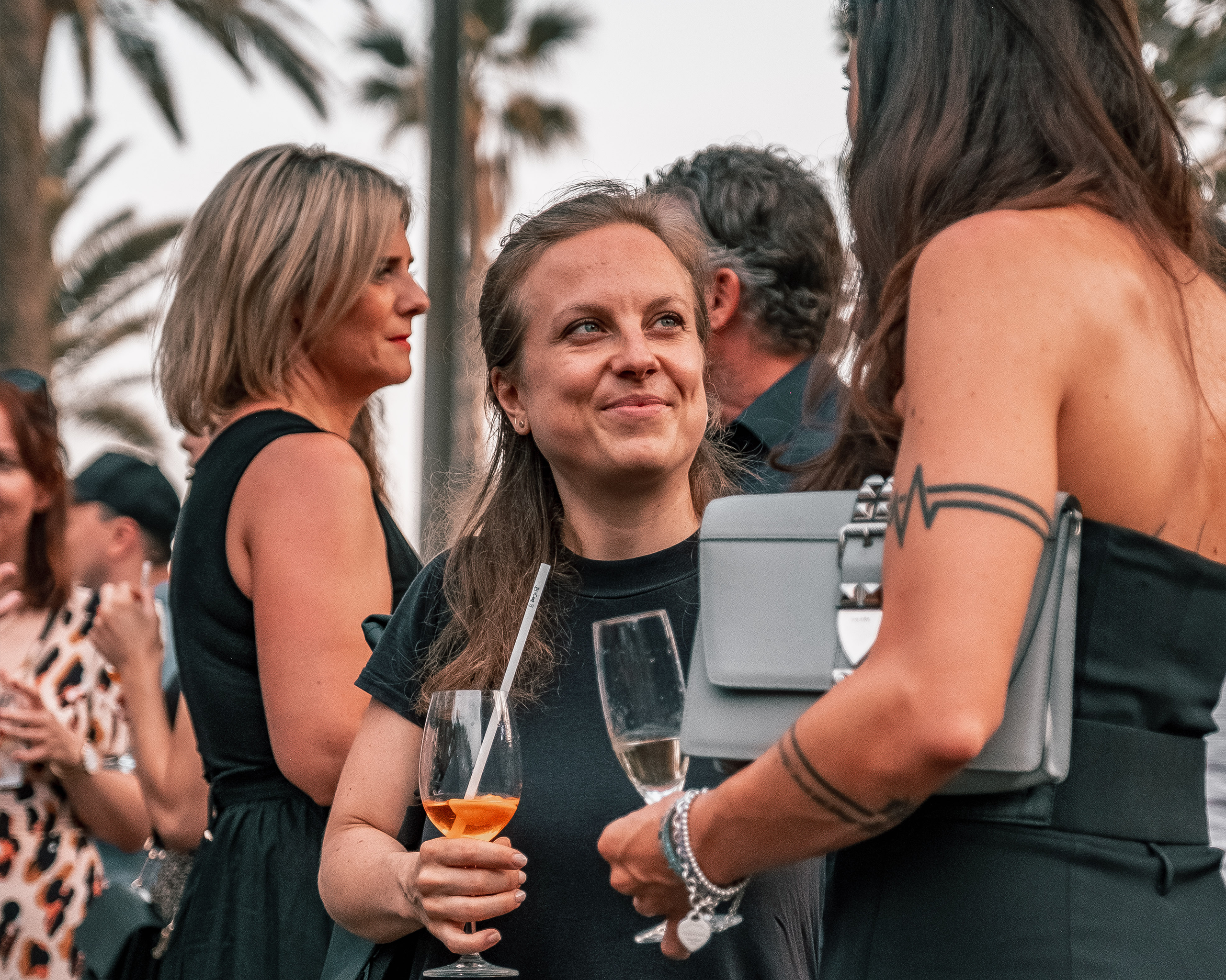 Two women having a drink while speaking to each other
