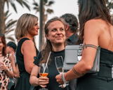 Team - Afterwork Two women having a drink while speaking to each other
