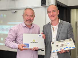 CoderDojo - Volunteering Team Two men standing with laptops in their hands and smiling to the camera