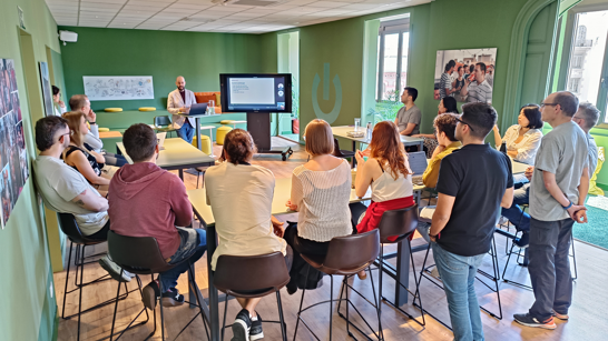 Group of people sitting and listening to a presentation