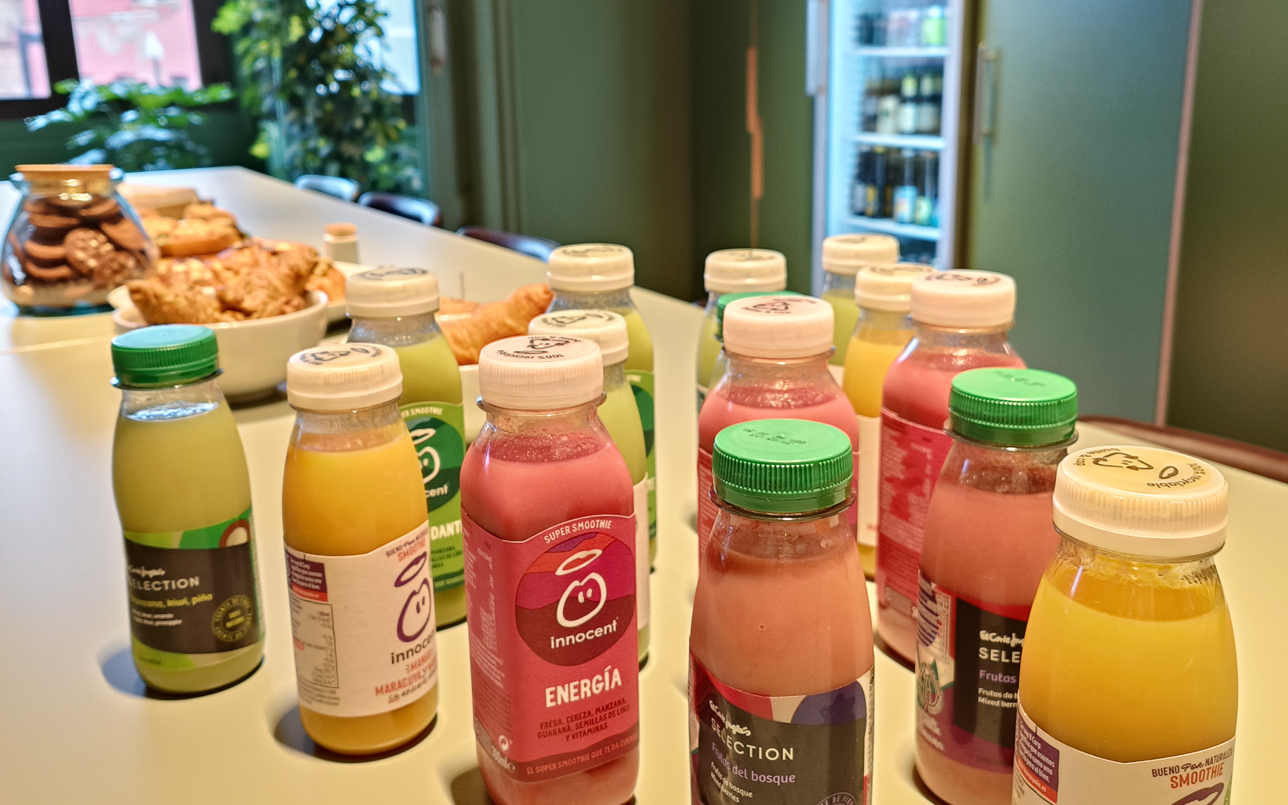 Breakfast table with bottles of smoothies in different colours