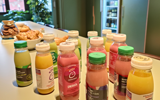 Breakfast table with bottles of smoothies in different colours