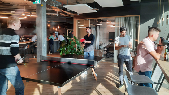 Employees playing ping pong