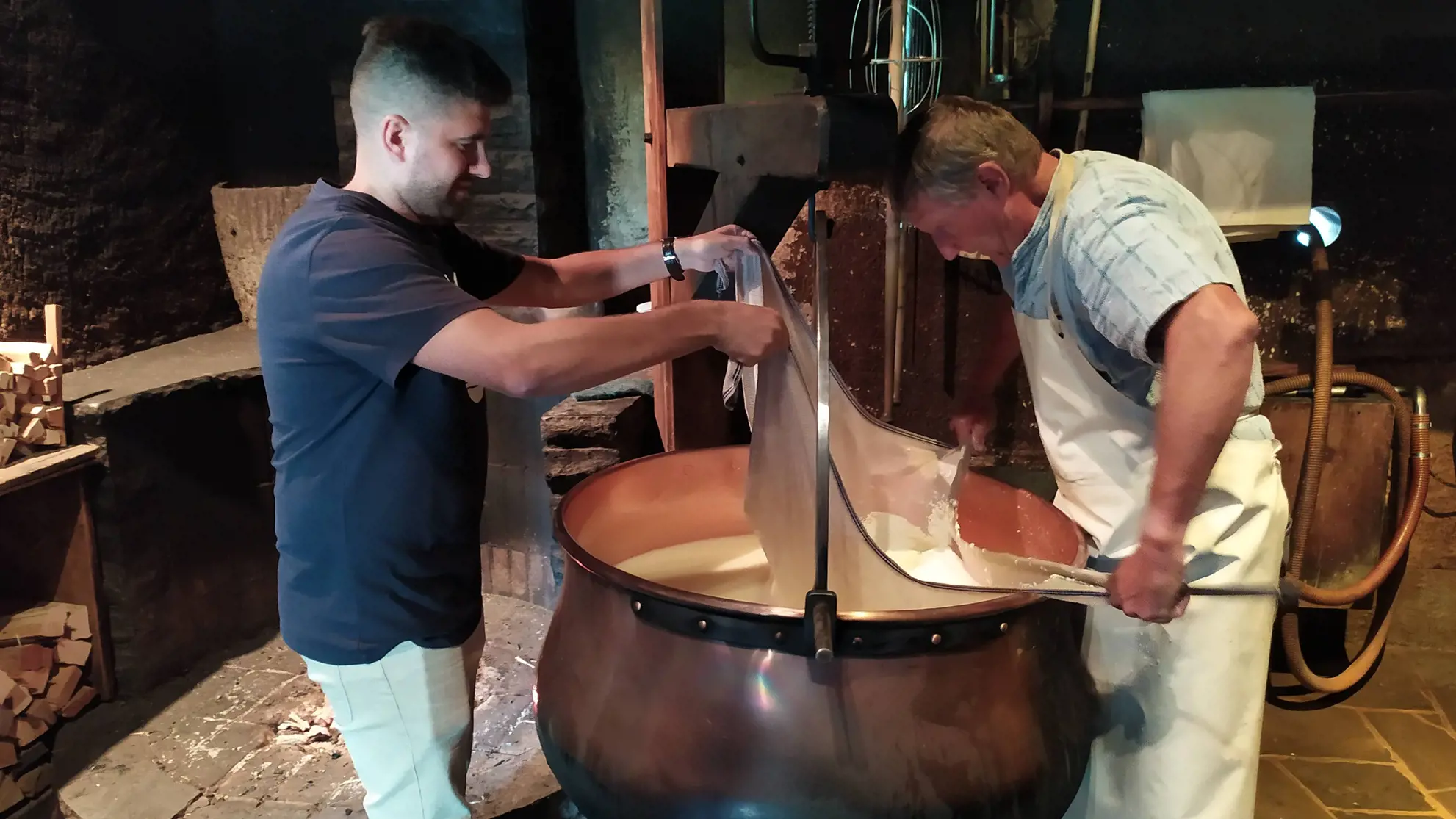 Visit to a swiss cheese factory with large cauldrons full of cheese