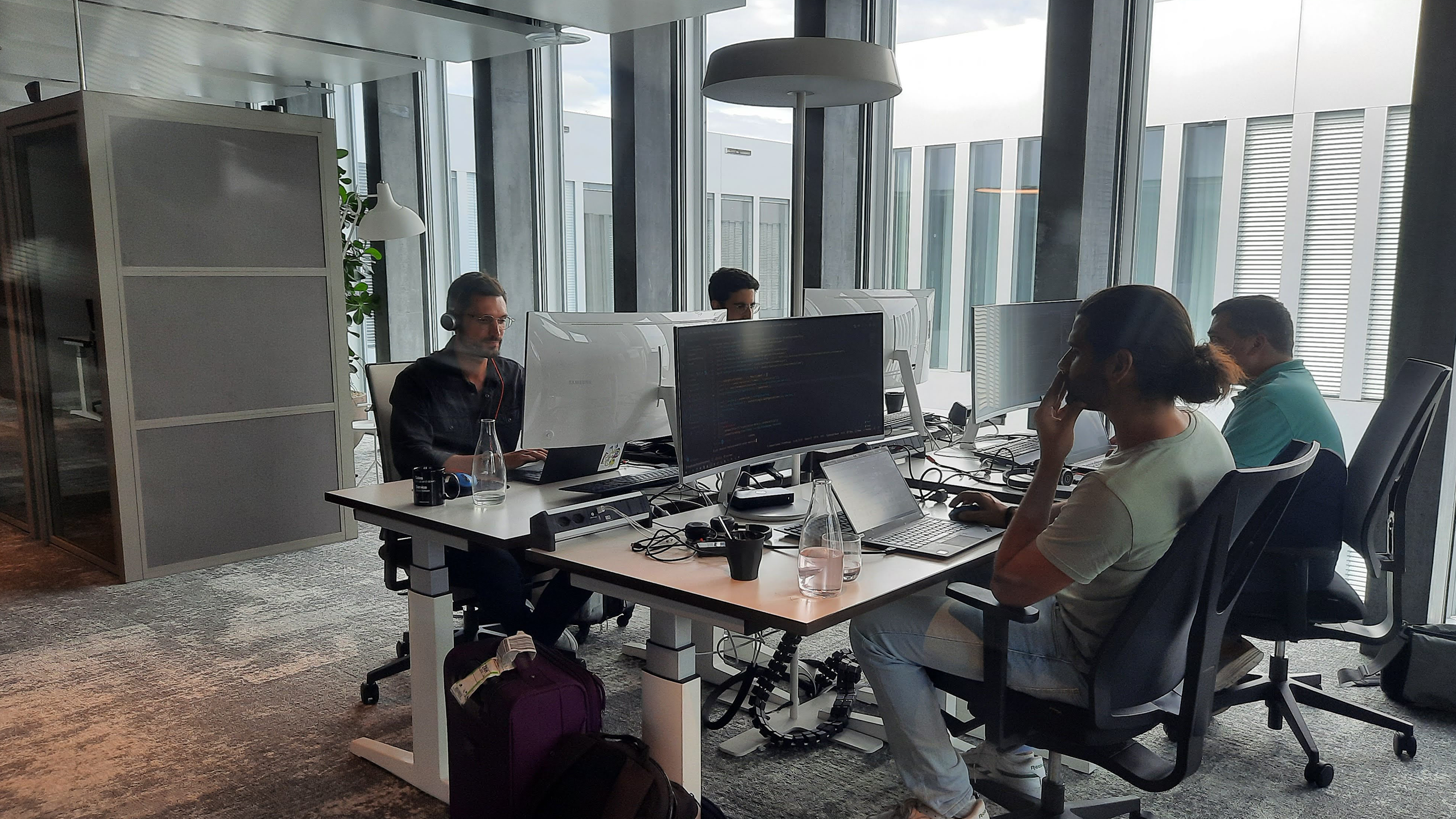 Employees sitting in front of a screen working