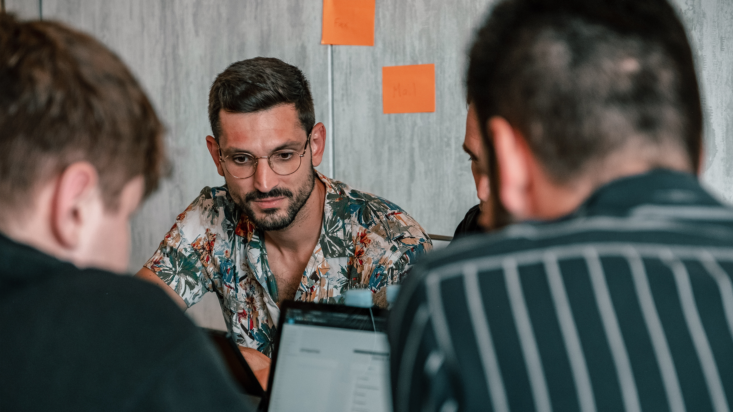 isolutions employee dressed in shirt at beach boot camp looking into his laptop