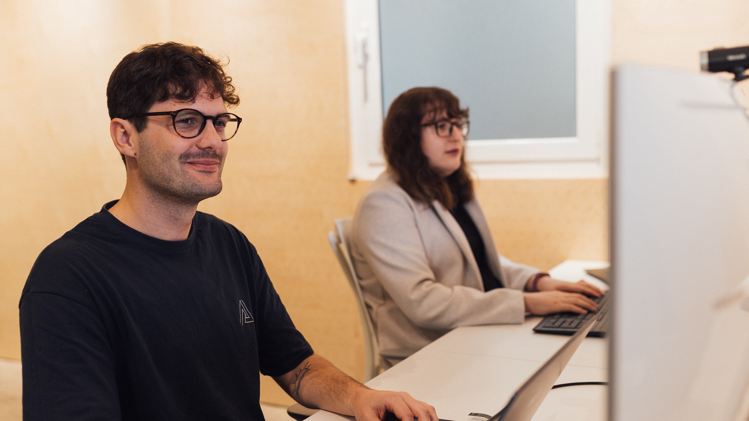 Two software developers happily at work 